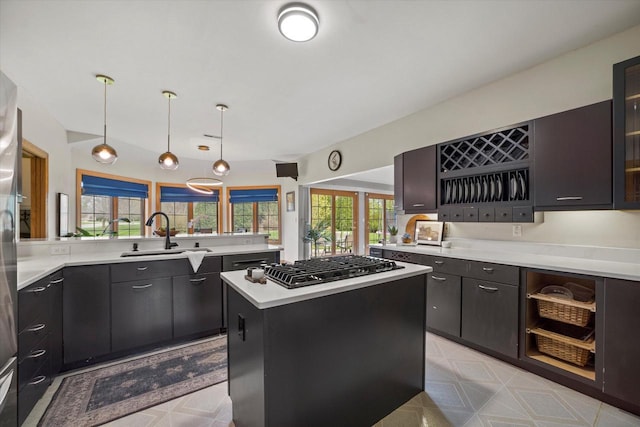 135 Emerald Dr, Mount Pleasant, WI 53406 - kitchen featuring a sink, stainless steel gas stovetop, light countertops, and a center island