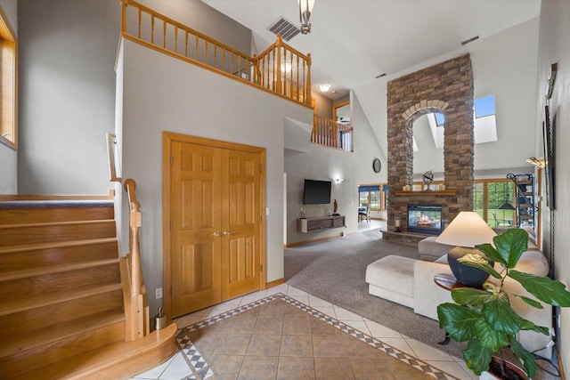 135 Emerald Dr, Mount Pleasant, WI 53406 - tiled living room with high vaulted ceiling, stairway, healthy amount of natural light, a fireplace, and baseboards