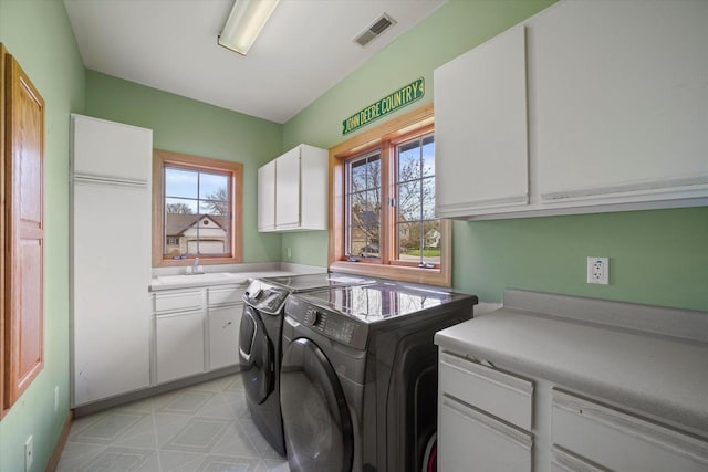 135 Emerald Dr, Mount Pleasant, WI 53406 - laundry room with cabinet space, washer and dryer, and light floors
