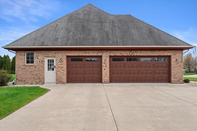 135 Emerald Dr, Mount Pleasant, WI 53406 - view of side of property featuring brick siding, a shingled roof, concrete driveway, and a garage