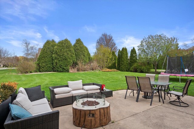 135 Emerald Dr, Mount Pleasant, WI 53406 - view of patio with a trampoline, an outdoor living space with a fire pit, and outdoor dining area