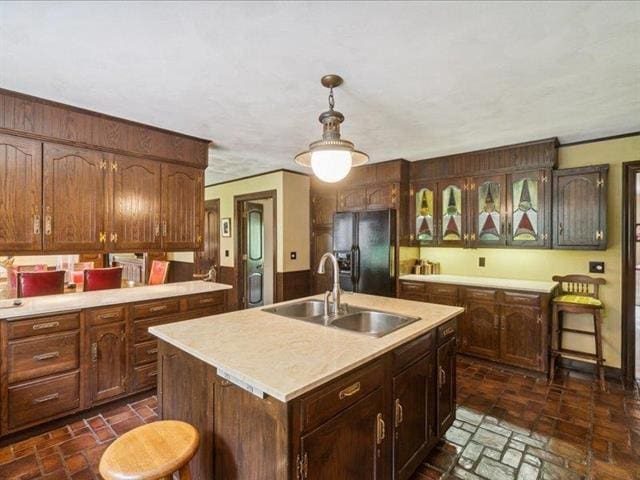 5140 N Kennedy Rd, Milton, WI 53563 - kitchen featuring black refrigerator with ice dispenser, a sink, light countertops, brick patterned floors, and a wainscoted wall