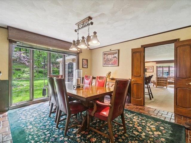 5140 N Kennedy Rd, Milton, WI 53563 - dining area featuring a chandelier and crown molding