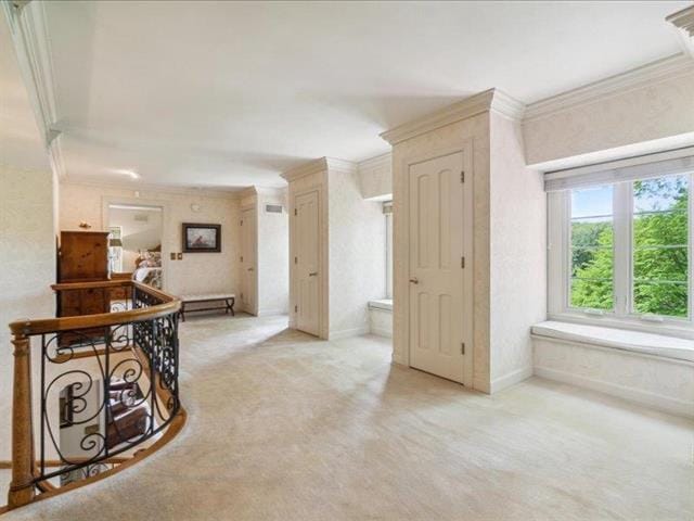 5140 N Kennedy Rd, Milton, WI 53563 - corridor featuring light carpet, ornamental molding, an upstairs landing, and baseboards