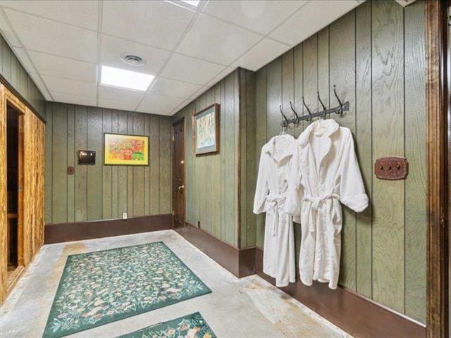 5140 N Kennedy Rd, Milton, WI 53563 - doorway featuring concrete floors, wooden walls, and a paneled ceiling