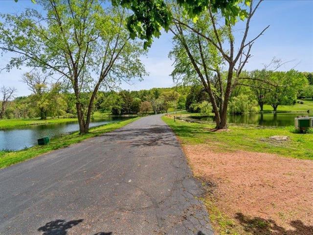 5140 N Kennedy Rd, Milton, WI 53563 - view of asphalt road with a water view