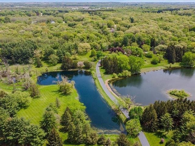 5140 N Kennedy Rd, Milton, WI 53563 - drone / aerial view of a nearby body of water and a forest