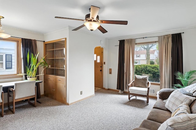 8808 W Burleigh St, Milwaukee, WI 53222 - living room featuring arched walkways, ceiling fan, baseboards, light carpet, and ornamental molding