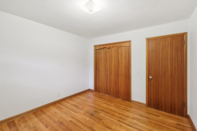 6013 Gateway Grn, Monona, WI 53716 - unfurnished bedroom with light wood-style flooring, a closet, and baseboards