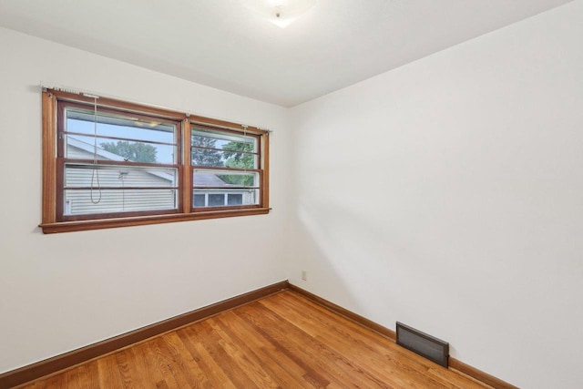 6013 Gateway Grn, Monona, WI 53716 - spare room featuring baseboards and light wood-style flooring