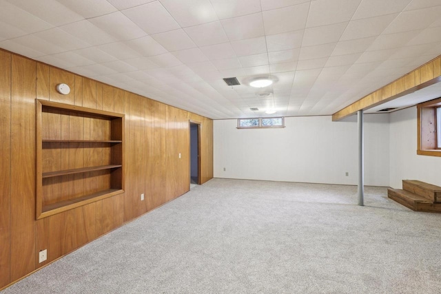 6013 Gateway Grn, Monona, WI 53716 - basement featuring light colored carpet, built in shelves, and wooden walls