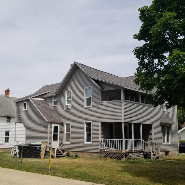 958 Elm St, Beloit, WI 53511 - back of property with a shingled roof, a yard, and covered porch
