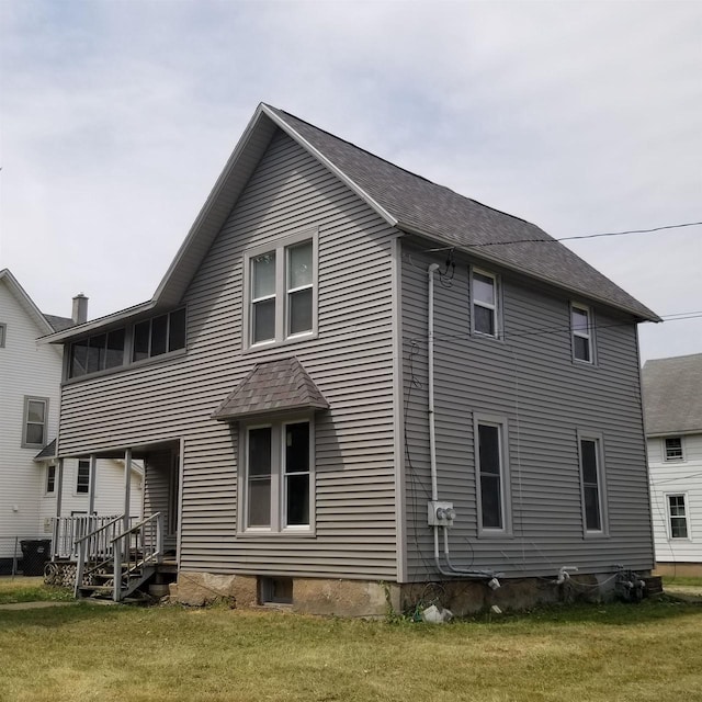 958 Elm St, Beloit, WI 53511 - rear view of property with a yard and a shingled roof
