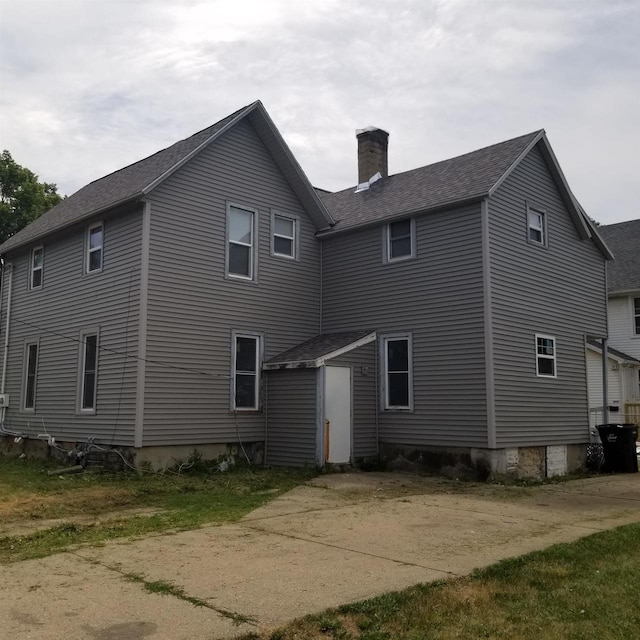 958 Elm St, Beloit, WI 53511 - rear view of house with a chimney and a shingled roof
