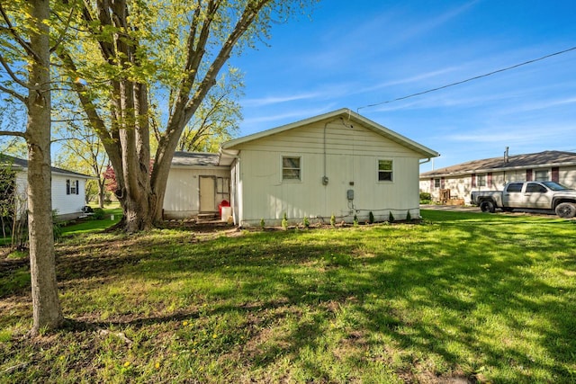 841 Legion Dr, Twin Lakes, WI 53181 - rear view of house featuring a lawn