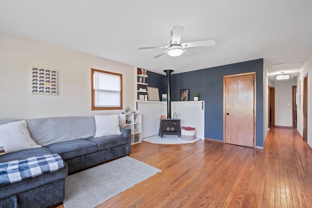 841 Legion Dr, Twin Lakes, WI 53181 - living area with a wood stove, attic access, wood-type flooring, and a ceiling fan