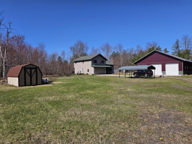 1983 US Highway 2, Florence, WI 54121 - view of grassy yard featuring an outbuilding, a garage, and a shed