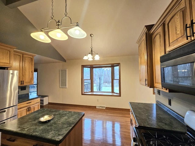 1983 US Highway 2, Florence, WI 54121 - kitchen featuring stainless steel appliances, a chandelier, lofted ceiling, dark wood-style floors, and baseboards