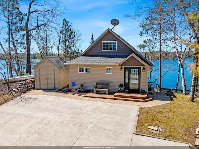 9331 N Marl Lake Rd, Pound, WI 54161 - view of front of property with a shingled roof, a shed, an outdoor structure, a deck, and a front yard