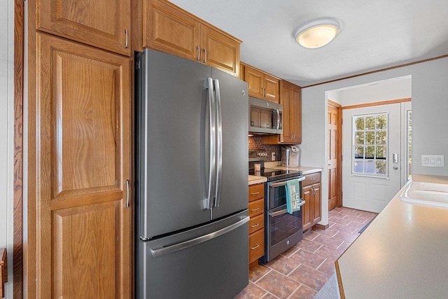 9331 N Marl Lake Rd, Pound, WI 54161 - kitchen with stainless steel appliances, light countertops, decorative backsplash, brown cabinetry, and a sink
