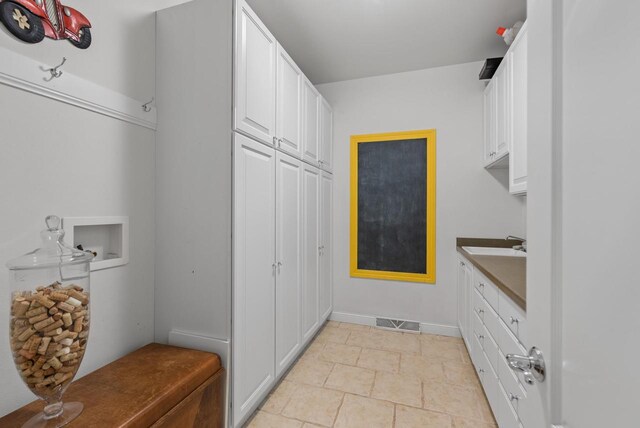 W4344 Carl Dr, Fond Du Lac, WI 54937 - laundry area with washer hookup, cabinet space, and baseboards