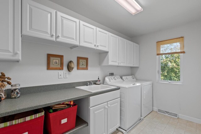 W4344 Carl Dr, Fond Du Lac, WI 54937 - washroom with cabinet space, washing machine and clothes dryer, baseboards, and light tile patterned floors