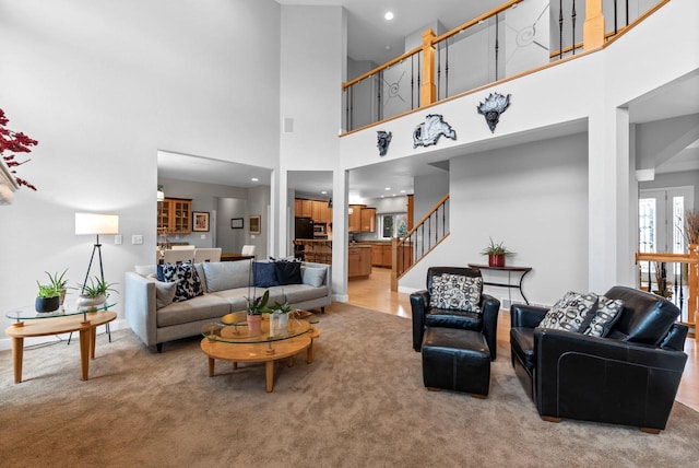 W4344 Carl Dr, Fond Du Lac, WI 54937 - living area with light colored carpet, a towering ceiling, stairs, and recessed lighting