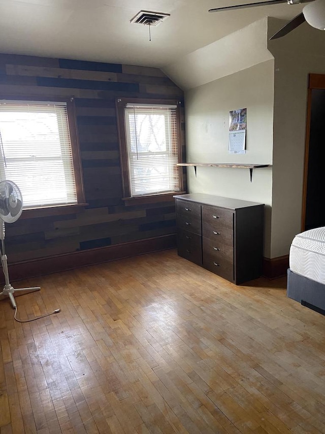 1040 N 1st St, Wisconsin Rapids, WI 54494 - unfurnished bedroom with light wood finished floors and vaulted ceiling