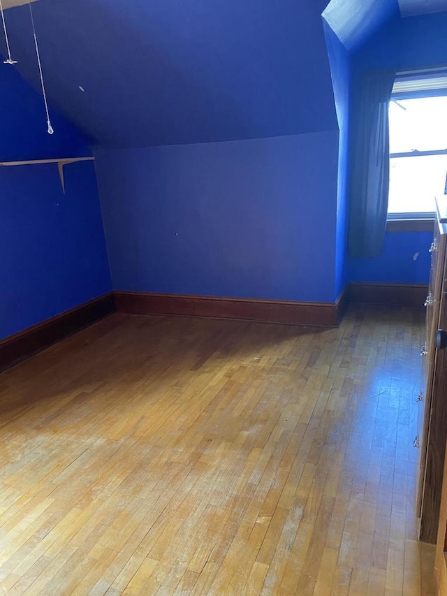 1040 N 1st St, Wisconsin Rapids, WI 54494 - additional living space featuring hardwood / wood-style flooring, vaulted ceiling, and baseboards
