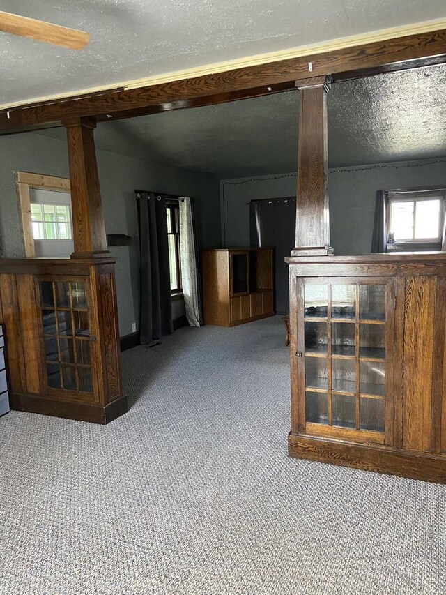 1040 N 1st St, Wisconsin Rapids, WI 54494 - unfurnished living room featuring carpet flooring and ornate columns