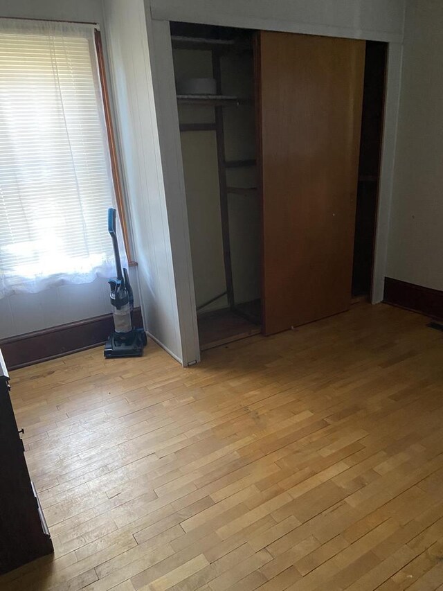 1040 N 1st St, Wisconsin Rapids, WI 54494 - unfurnished bedroom with light wood finished floors and a closet