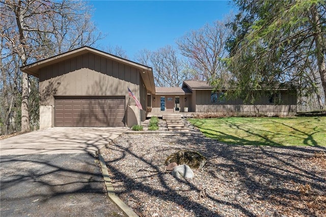 1395 25th St, Houlton, WI 54082 - ranch-style house with an attached garage, asphalt driveway, and a front yard