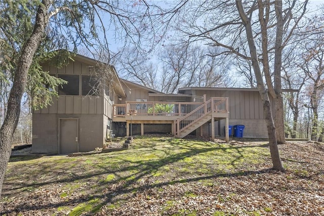 1395 25th St, Houlton, WI 54082 - rear view of house with a wooden deck, stairs, and board and batten siding