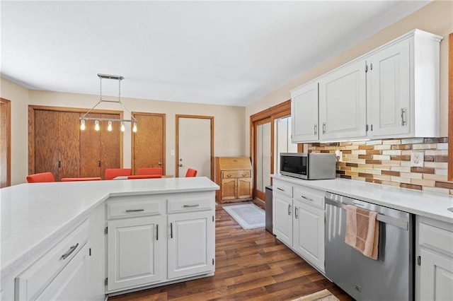 1395 25th St, Houlton, WI 54082 - kitchen featuring appliances with stainless steel finishes, light countertops, decorative backsplash, and white cabinetry