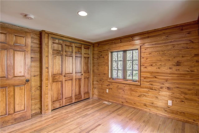 N3858 1000th St, Eau Claire, WI 54703 - unfurnished room featuring a smoke detector, light wood-style flooring, wooden walls, and recessed lighting