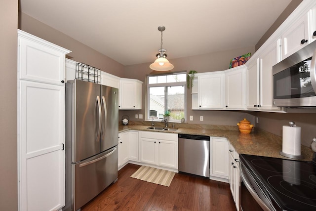18235 W Wisconsin Ave, Brookfield, WI 53045 - kitchen featuring appliances with stainless steel finishes, a sink, white cabinets, and dark wood-style floors