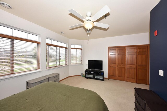 18235 W Wisconsin Ave, Brookfield, WI 53045 - bedroom with light colored carpet, baseboards, a closet, and a ceiling fan