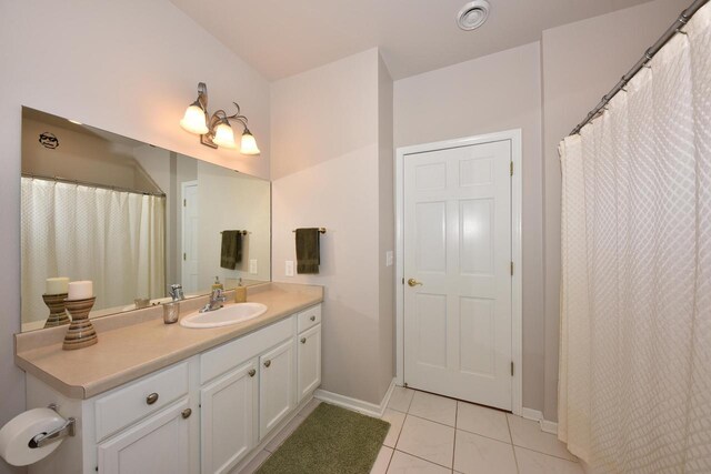 18235 W Wisconsin Ave, Brookfield, WI 53045 - bathroom featuring tile patterned flooring, baseboards, and vanity