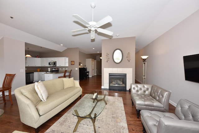 18235 W Wisconsin Ave, Brookfield, WI 53045 - living area featuring ceiling fan, vaulted ceiling, dark wood-style flooring, a fireplace, and baseboards