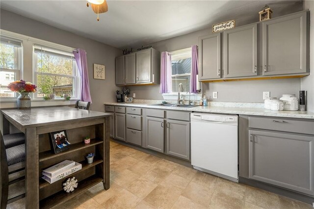 719 Huebsch Blvd, Eau Claire, WI 54701 - kitchen featuring gray cabinetry, white dishwasher, a sink, and plenty of natural light