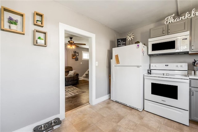 719 Huebsch Blvd, Eau Claire, WI 54701 - kitchen featuring white appliances, gray cabinetry, a ceiling fan, baseboards, and light countertops