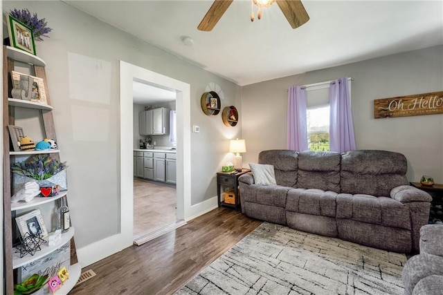 719 Huebsch Blvd, Eau Claire, WI 54701 - living area with a ceiling fan, dark wood-type flooring, and baseboards