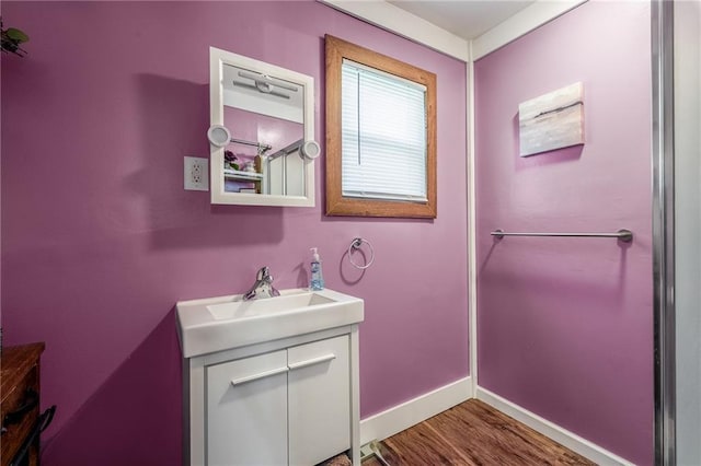 719 Huebsch Blvd, Eau Claire, WI 54701 - bathroom with vanity, wood finished floors, and baseboards