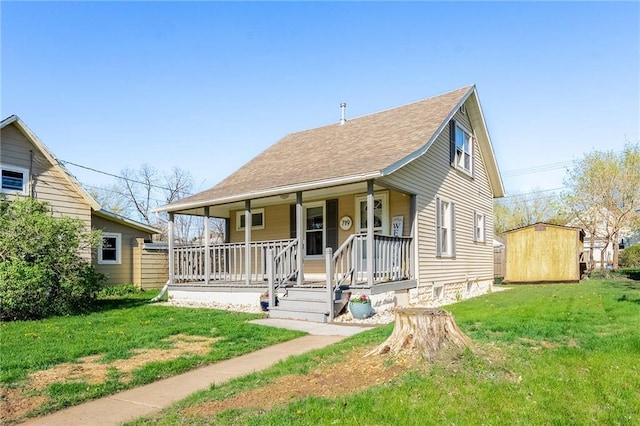 719 Huebsch Blvd, Eau Claire, WI 54701 - view of front of home featuring covered porch, a front lawn, a storage unit, and roof with shingles