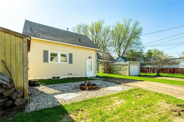 719 Huebsch Blvd, Eau Claire, WI 54701 - back of property with a fire pit and an outbuilding