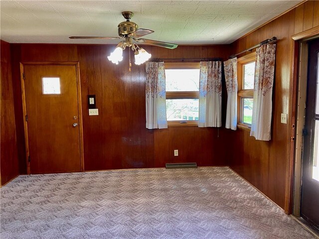 318 Spruce St, Spooner, WI 54801 - carpeted foyer with ceiling fan and wooden walls