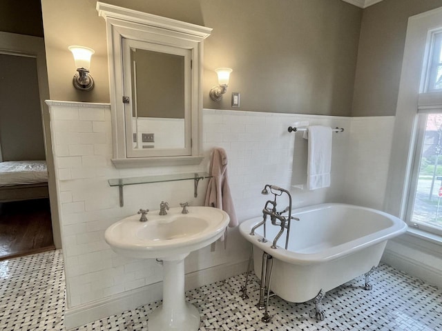 2701 N Lake Dr, Milwaukee, WI 53211 - full bath featuring a freestanding tub, a wainscoted wall, tile walls, and tile patterned floors