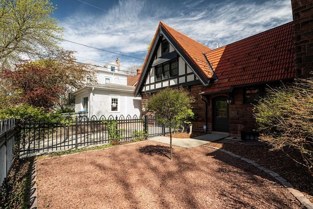 2701 N Lake Dr, Milwaukee, WI 53211 - view of front of house with a tiled roof and stone siding