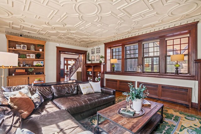 2701 N Lake Dr, Milwaukee, WI 53211 - living area with an ornate ceiling, radiator, stairs, and wood finished floors