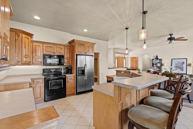 kitchen with black appliances, a sink, light tile patterned floors, light countertops, and ceiling fan